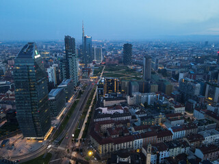 Milan, Italy - May 08, 2021: Aerial view of Milan Porta Nuova district, city skyline, business buildings and skyscrapers of Palazzo Regione Lombardia, Unicredit Tower, Bosco Verticale in Lombardy.