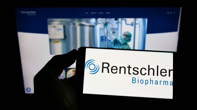 Stuttgart, Germany - 05-15-2022: Person holding cellphone with logo of German company Rentschler Biopharma SE on screen in front of business webpage. Focus on phone display.