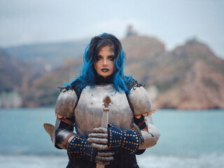 Medieval knight woman in armor prays, blessing before the battle. - obrazy, fototapety, plakaty