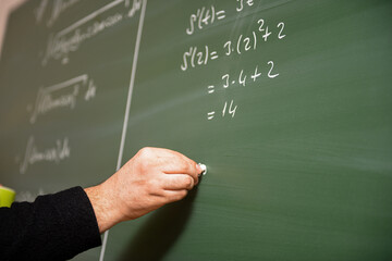 Teacher telling math lesson on the chalkboard