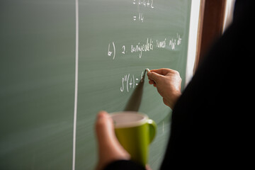 Teacher telling math lesson on the chalkboard