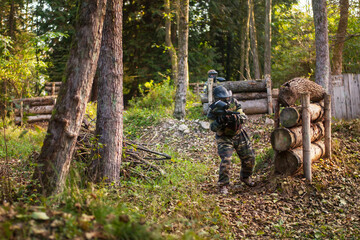 children playing paintball in the forest