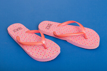 Beach accessories. Flip flops and starfish on colored background. Top view Mock up with copy space