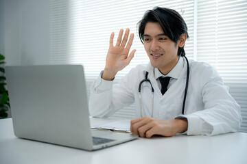 Fototapeta na wymiar Asian medical specialists provide telemedicine consultations to flu patients. Doctor explains the symptoms of the disease and treats it through a video call. Telehealth , Doctor online.