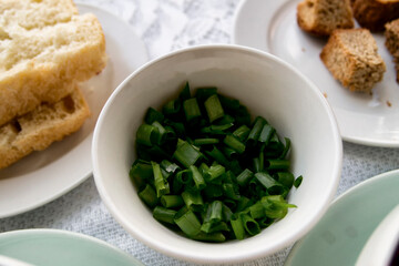 Chopped green onion in ceramic bowl