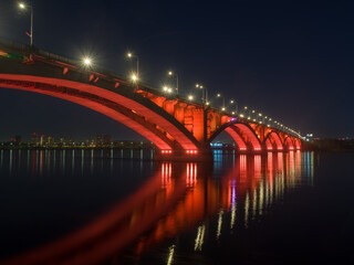 Fototapeta na wymiar Siberian city of Krasnoyarsk. Night view of the Yenisei River. Communal bridge