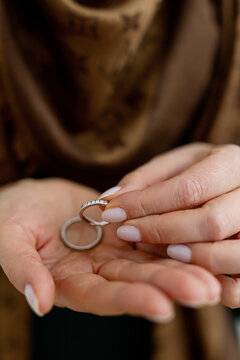 PERM, RUSSIA FEBRUARY 13, 2022: woman holds a Tiffany wedding ring in her hand against a Louis Vuitton scarf.