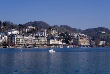 Fototapeta na wymiar Lake Luzern with waterfront and luxury hotels on a sunny spring day. Photo taken March 23rd, 2022, Lucerne, Switzerland.