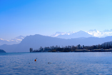 Lake Luzern seen from the old town of City of Luzern with Swiss Alps in the background on a sunny spring day. Photo taken March 23rd, 2022, Lucerne, Switzerland.