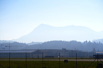 Panoramic view of Swiss Alps with Mount Rigi seen from City of Emmen on a sunny spring day. Photo taken March 23rd, 2022, Emmen, Switzerland.