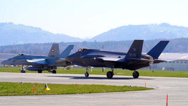 McDonnell Douglas FA-18 Hornet and Lockheed Martin F-35 at Swiss Air Force Airbase Emmen, Canton Lucerne, on a sunny spring noon. Photo taken March 23rd, 2022, Emmen, Switzerland.