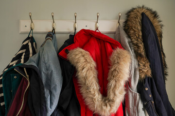Row of winter coats hanging on hooks