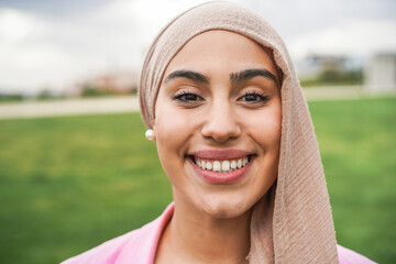 Young arabian girl smiling on camera outdoor - Focus on face