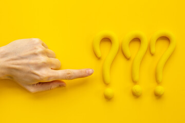 Hand points to question mark sign. Solving problem or search solution concept