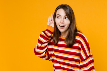 Young happy curious nosy caucasian woman 20s wearing red striped sweatshirt try to hear you...