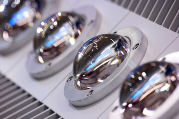 Close up turned off powerful LED lamps. Shiny reflective steel semi spheres.