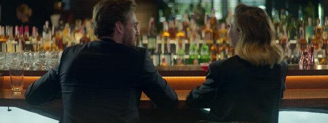 Beautiful Caucasian couple having a date in a stylish restaurant, talking and laughing. Shot with 2x anamorphic lens
