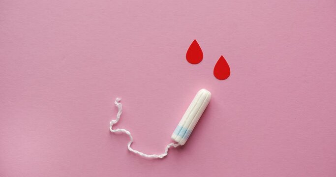 Feminine hygienic tampon and drops of blood. Menstrual cycle. Looped stop motion animation
