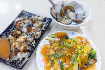 Taiwanese cuisine with oyster omelet, clam soup and fresh oyster with sauce