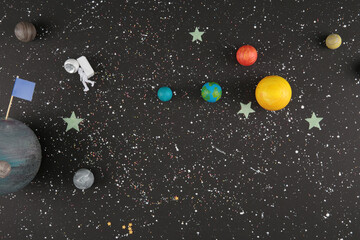 toy planets and astronaut in space