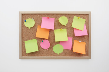 colorful post it note papers on cork board