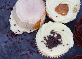 cupcake fallen upside down on icing with messed sprinkles 