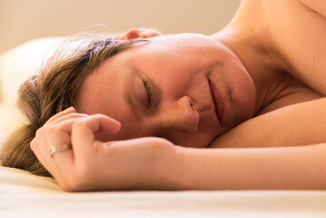 Fototapeta premium Portrait of a thirty year old attractive woman sleeping on her side