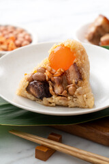 Zongzi. Rice dumpling for Dragon Boat Festival on bright marble table background with ingredient.