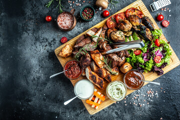 delicious grilled meat with vegetable. Mixed grilled bbq meat with vegetables on wooden platter. Restaurant menu, dieting, cookbook recipe top view