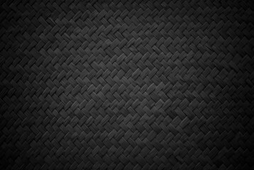 Old black reed weaving mat texture background, pattern of woven rattan mat in vintage style.