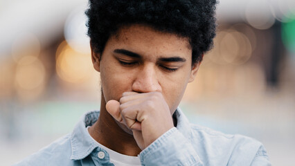 Male portrait sad african american man sick guy indoors coughing covering mouth with hand sore throat problems with breathing covid symptoms asthma allergy trouble coronavirus bad feeling illness - obrazy, fototapety, plakaty
