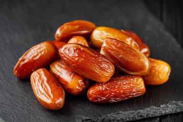 juicy royal dates on a black wooden rustic background