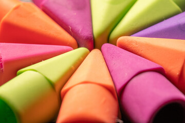 Macro image of colorful pencil erasers arranged in random patterens. Good backdrop concept. - obrazy, fototapety, plakaty