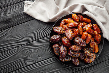 juicy royal dates on a black wooden rustic background - Powered by Adobe