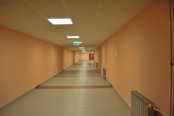 corridor of a modern building, orange walls, lights on the ceiling - obrazy, fototapety, plakaty