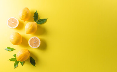 Summer composition made from oranges, lemon or lime on pastel yellow background. Fruit minimal concept. Flat lay, top view, copy space.