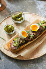 Homemade sandwich with turkey, pickles and egg for breakfast, copy space