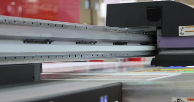 Modern Digital Large format UV printer. Printing production technologies. UV pinning is the process of applying a dose of low intensity ultraviolet light to a UV curable ink