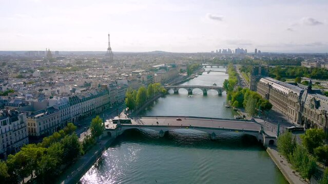 Paris Aerial Video With View Of Bridges, Seine River, Pont Des Arts And Eiffel Tower. Historic Parisian City Center From Above During Warm Summer. Famous Holidays Vacation Destination