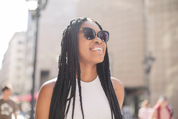 African girl with sunglasses walk in the city