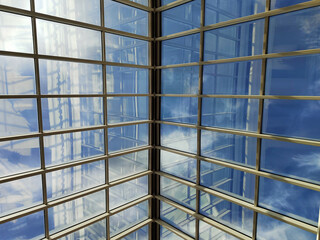 Skylight or glass sunroof ceiling of a building. Window in commercial office or industrial building. Modern design architecture, or energy conservation model using nature sunlight concept.