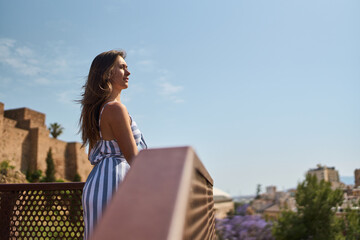 young woman looking at the views from a panoramic viewpoint of the Alcazaba of Málaga