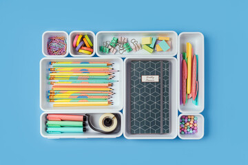 Stylish colored school stationery is arranged in organizers. Creative Drawer Organizing. Storage...
