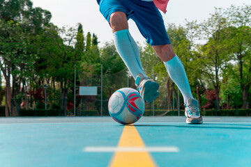 Image of a man starting a dribble with the ball on the yellow line. Close-up image of a young boy...