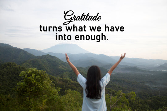 Thankful inspirational quote - Gratitude turns what we have into enough. Happy person with arms raised against hill and mountain range. Gratitude concept.