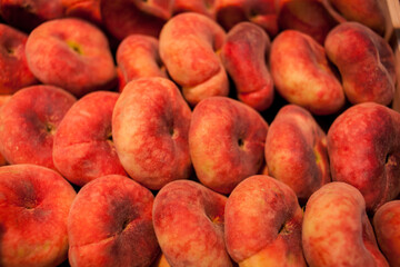 fig peach. saturn peaches. flat peaches harvest. many peaches. Fresh fruit at farmers' market:...