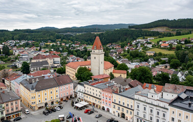 Drone view of the Altstadt Freistadt square. Old church, clock tower on the square in Austria, Tyrol