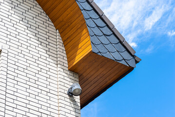 The church has a classic PVC soffit that imitates wood with a white brick facade.