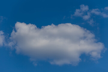 Naklejka na ściany i meble closeup cumulus cloud on blue sky, beautiful natural background