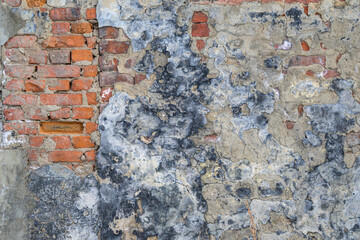 Grunge old red brick and plaster wall texture